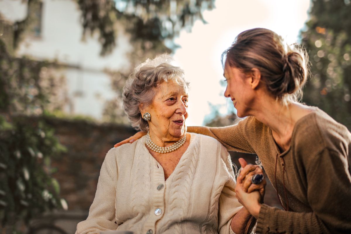 An older woman talking with a younger family member